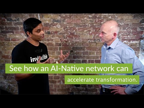 “Sudheer Matta appears on the left and Neil Collins appears on the right before a brick wall and the text “See how an AI-Native network can accelerate transformation” in white font on a green ribbon appears at the bottom of the screen.